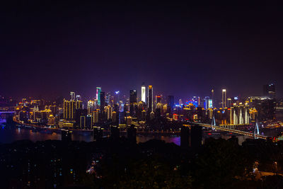 High angle view of illuminated buildings against sky at night