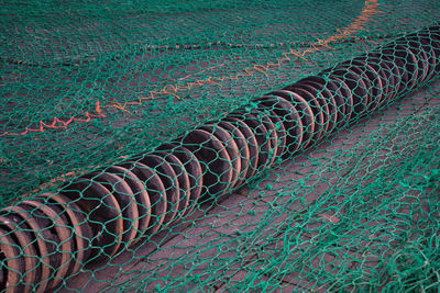 Full frame shot of fishing net on field