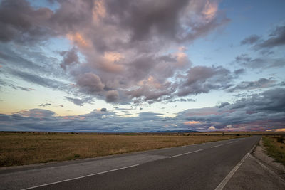 Scenic view of road against sky during sunset