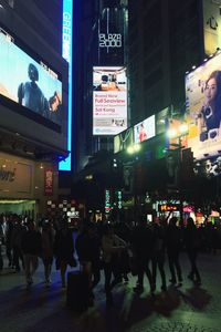 People walking on road in city at night