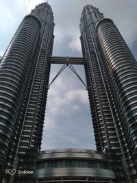 Low angle view of buildings against cloudy sky