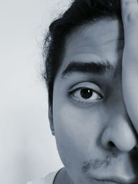 Close-up portrait of young man against white background