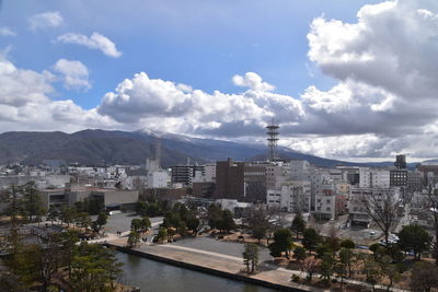 High angle view of buildings and trees against sky