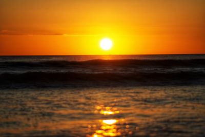 Scenic view of sea against romantic sky at sunset