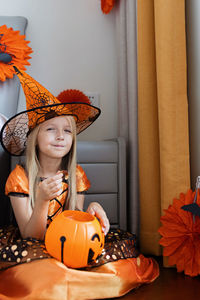 Cute girl wearing costume sitting at home