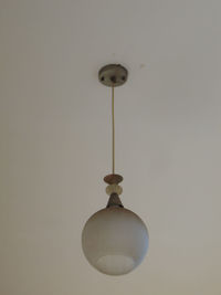 Close-up of electric lamp against wall