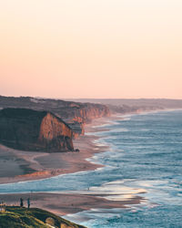Scenic view of sea against clear sky during sunset