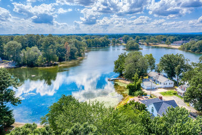 High angle view of trees by lake against sky