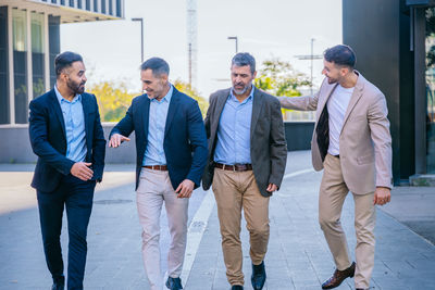 Full length of business colleagues standing in office
