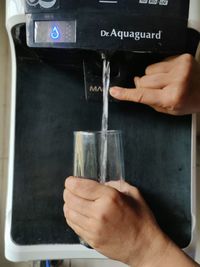 Close-up of hand holding coffee cup