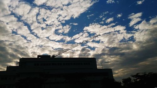 Low angle view of silhouette building against sky