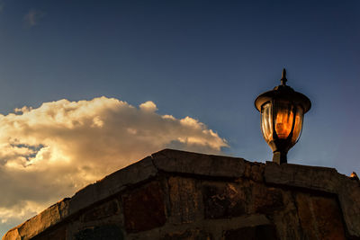 Low angle view of illuminated street light against sky