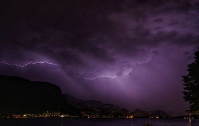 Lightning in sky over city at night