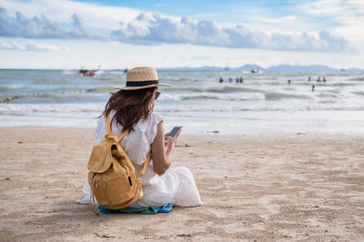 Man using mobile phone at beach