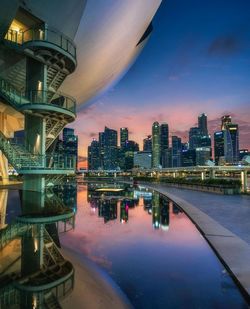 Reflection of buildings in city against sky