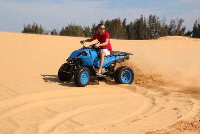 Man riding motorcycle on sand