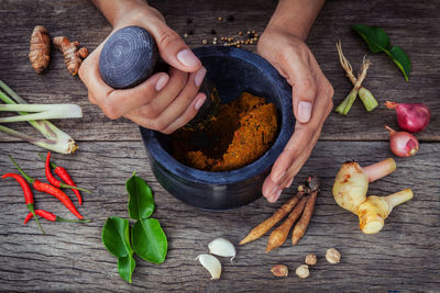 Cropped hands using mortar and pestle