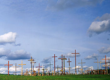 View of crosses on landscape against blue sky