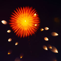 Low angle view of illuminated fireworks against sky at night