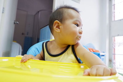 Cute baby boy sitting at home