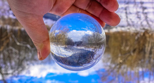 Close-up of hand holding glass of water