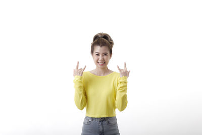 Portrait of a teenage girl standing against white background
