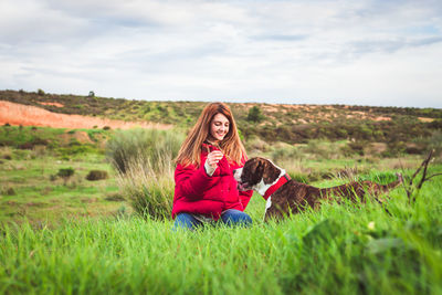 Woman with dog on field