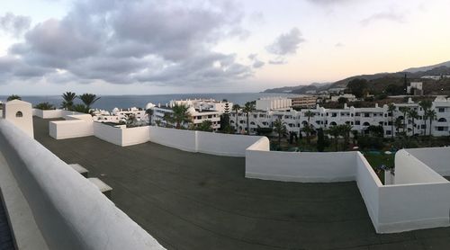 High angle view of buildings against cloudy sky