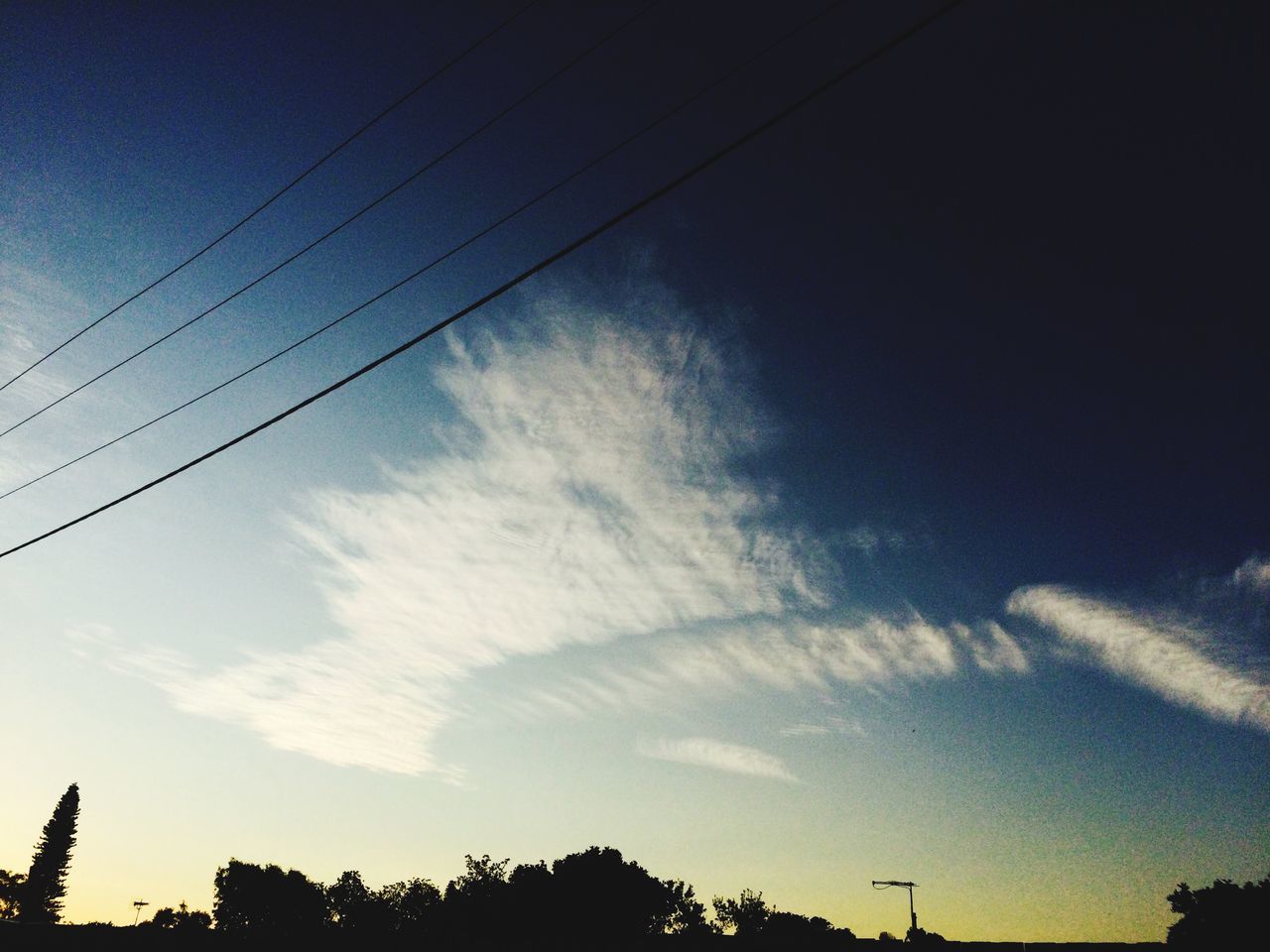 low angle view, silhouette, sky, power line, tree, electricity pylon, electricity, cloud - sky, beauty in nature, nature, vapor trail, tranquility, cable, dusk, scenics, power supply, blue, tranquil scene, cloud, outdoors