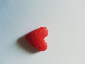 Close-up of red rose over white background