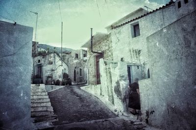 Exterior of narrow walkway against sky