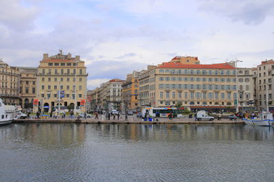 Buildings in city against cloudy sky