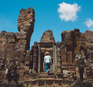 Rear view of women in temple against sky