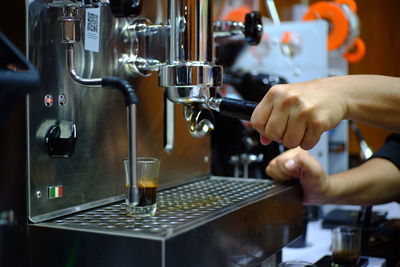 Cropped hand of man working in cafe