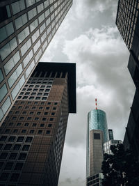 Low angle view of buildings against cloudy sky