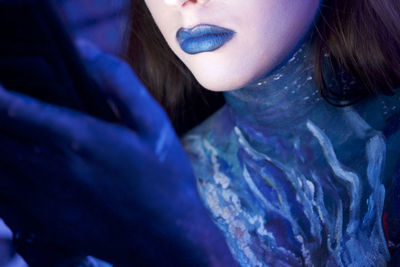 Close-up midsection of girl in blue lipstick