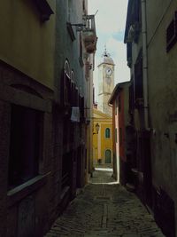 Narrow alley amidst buildings in city