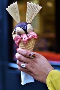 Close-up of hand holding ice cream