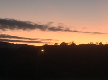 Silhouette landscape against sky during sunset