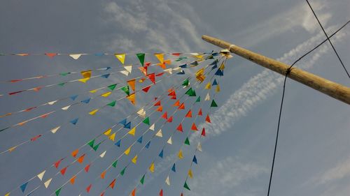 Low angle view of multi colored hanging against sky