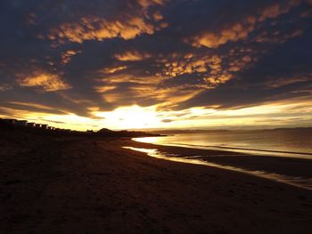 Scenic view of beach against sky during sunset