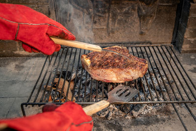 Closeup of italian roasted steak on barbecue grill. appetizing meat cooking on fire and embers