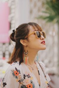 Portrait of young woman looking away outdoors