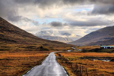 Road amidst landscape against sky