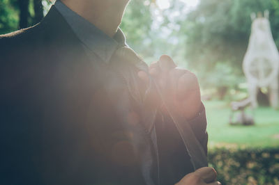 Close-up of businessman holding tie