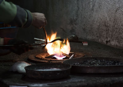 Close-up of person hand and flame 