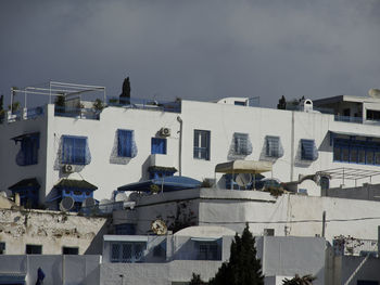 Low angle view of buildings in town against sky