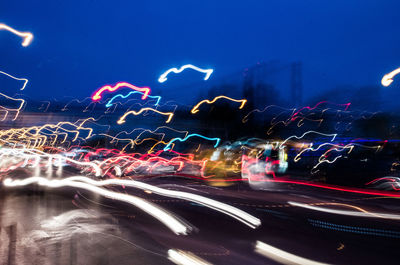 Light trails on road in city at night