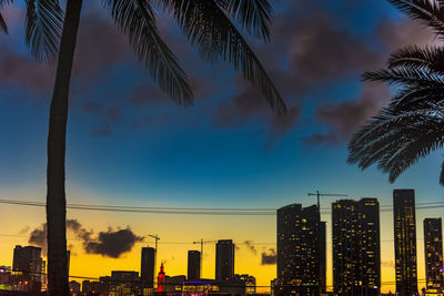 Low angle view of modern buildings against sky during sunset