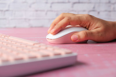 Midsection of person using smart phone on table